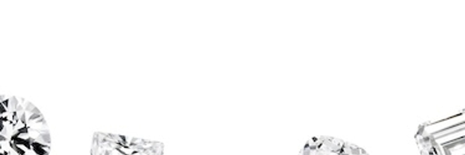 Various shapes of sparkling diamonds arranged on a plain white background."